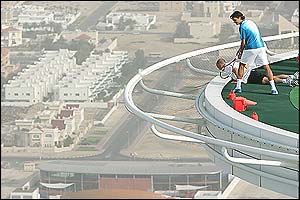 Andre Agassi and Roger Federer share a practice session on a helipad at Dubai's most luxurious hotel